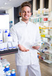 © JackF - Positive man pharmacist standing among shelves