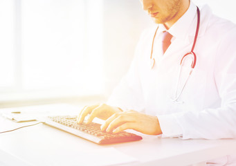 Wall Mural - male doctor typing  on the keyboard