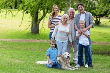 Wall Mural - Family with dog in the park