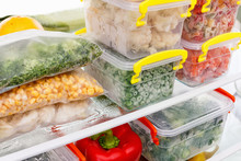 Frozen Food In The Refrigerator. Vegetables On The Freezer Shelves.