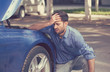 © pathdoc - Man with broken down car flat tire in the middle of the street