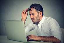 Man With Glasses Having Eyesight Problems Confused With Laptop Software