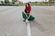 © ADDICTIVE STOCK - Teen girl sitting on asphalt road