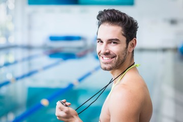 Wall Mural - Handsome man holding stopwatch