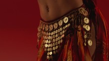 Beautiful Traditional Oriental Belly Dancer. Oriental Girl Dancing On Red Background. Studio Shoot With Fire. Shot On RED EPIC DRAGON Cinema Camera In Slow Motion.