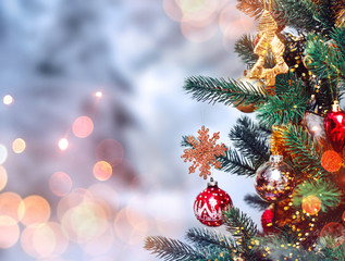 Wall Mural - christmas tree background and christmas decorations with snow, blurred, sparking, glowing. happy new