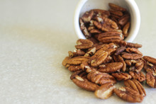 Pecans Spilling Out Of A Container, Positioned Off Right Edge