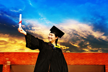 Beautiful female graduate wearing a graduation gown