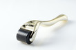 Golden derma roller for medical micro needling therapy. Tool also known as: Derma roller, mesoroller, meso-roller, mesopen.