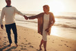 © Jacob Lund - Senior couple walking on the beach together at sunset