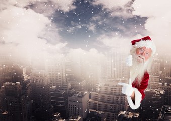 Poster - Digital composite of santa claus peeking from the buildings