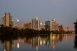 Austin skyline reflection off Lady Bird Lake on supermoon evening viewed from Zilker Park trail.