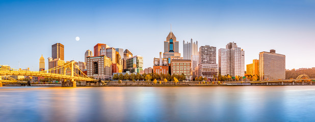 long exposure of pittsburgh downtown skyline and roberto clemente bridge, on a sunny afternoon, as v