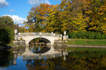 Vintage Viskontiev bridge in the autumn landscape. Pavlovsk Palace Park. Saint-Petersburg, Russia