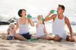 © JackF - couple with two kids drinking fresh water on sandy beach