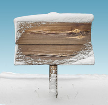 Wooden Signpost With Snow And Blue Sky