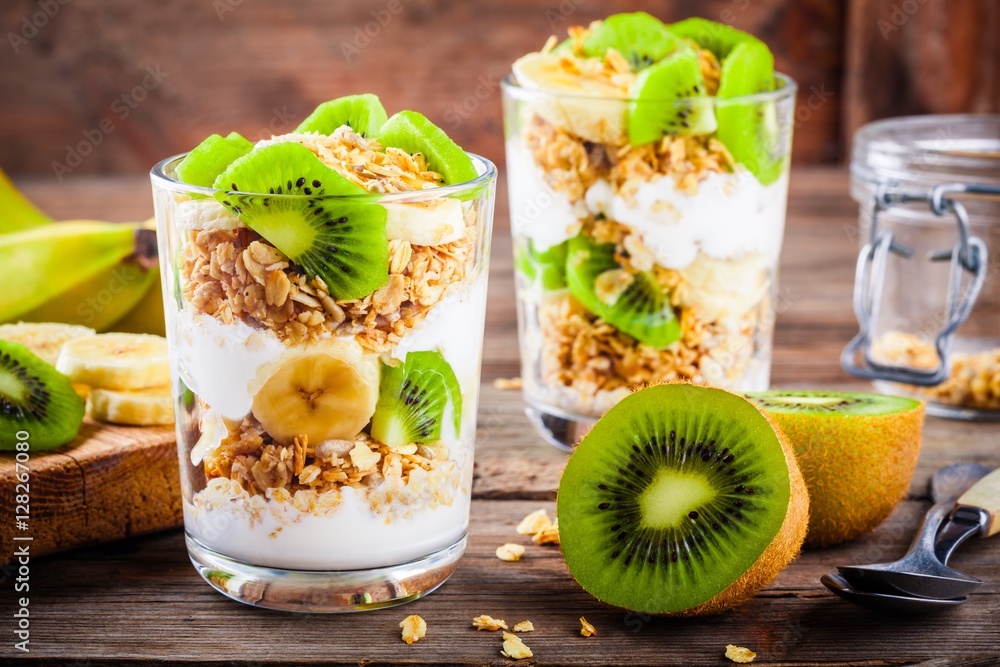 Healthy breakfast yogurt parfait with granola, banana and kiwi Stock