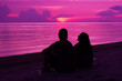 © romablack - Silhouette of the couple enjoying the sunset on the beach