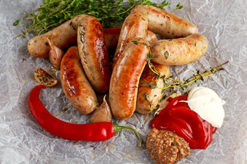 Wall Mural - Home-made Pork Sausages on crumpled paper with thyme