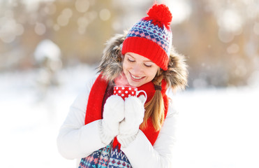 Poster - happy young woman with a cup of hot tea in winter  walk