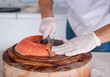 Chef cutting fresh salmon