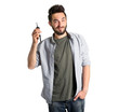 © Africa Studio - Young handsome man holding car key on grey background