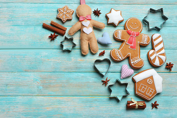 Wall Mural - Delicious Christmas cookies with cutters on wooden background