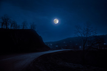 full moon over road at night
