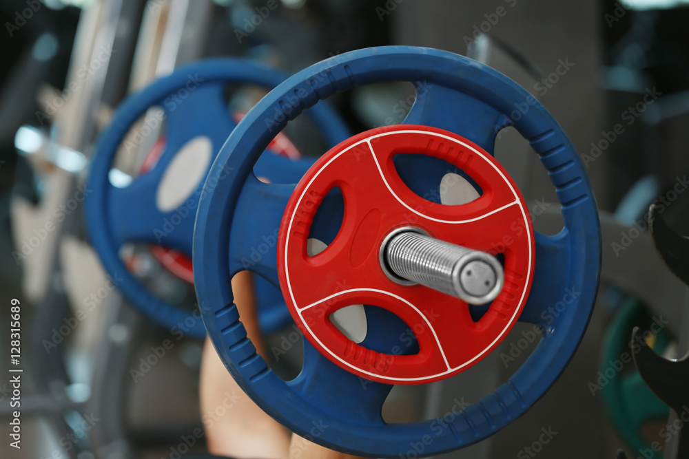 Athletic man training with barbell in gym