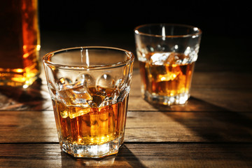 Canvas Print - Glasses of whisky on wooden table closeup