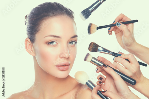 Poster Young woman with make up brush, isolated on white background