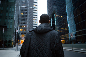 Back view of young African American professional in the city