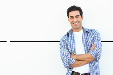 Wall Mural - Handsome man wearing blue plaid shirt with arms crossed