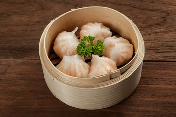 Chinese dumpling in a bamboo steamer box