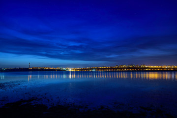 night view at blue hour of galati city, romania with reflections