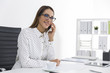 © ImageFlow - Positive woman in a polka dot blouse is on the phone