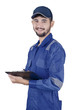 © Creativa Images - Young mechanic holds clipboard