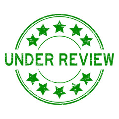 Sticker - Grunge green under review with star icon round rubber stamp