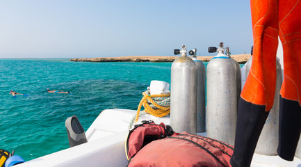 Oxygen tanks on the deck of the yacht near diving suit