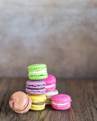 Wall Mural - Colorful macarons on the wooden background