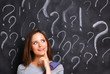 © shefkate - Young girl with question mark on a gray background