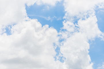 Wall Mural - looking up at big white cloud and light ray behind cloud with bl
