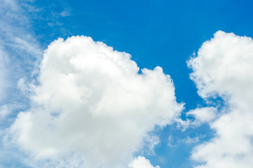 Wall Mural - looking up at big white cloud and light ray behind cloud with bl