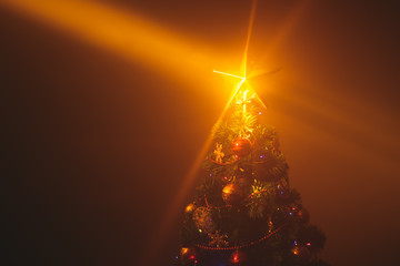 Christmas tree with shining star and dense mist