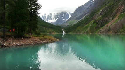 Wall Mural - The top of the mountain are covered with glaciers flowing down to the rocky slope. Altai, the North-Chuya ridge - Highlands region of Siberia. Lake Shavla and peaks reflecting in the water