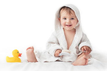 little baby smiling under a white towel