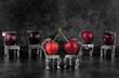 Red delicious ripe cherries on vintage small silver chairs and dark background with copy space