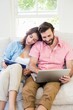 © WavebreakMediaMicro - Couple using digital tablet and laptop