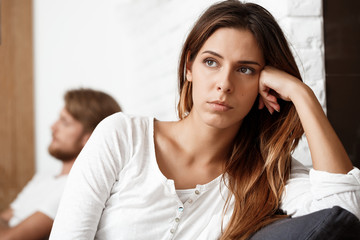 Dissapointed beautiful brunette girl in quarrel with her boyfriend background.