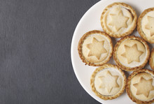 A Plate Full Of Freshly Baked Mince Pies On A Rustic Slate Background With Blank Space At Side